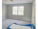 Bright bedroom with neutral walls, carpeted floor and a blue car shaped bed at 75 Price Dr, Locust Grove, GA 30248
