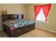 Cozy bedroom with a dark wood bed frame and red curtains at 75 Price Dr, Locust Grove, GA 30248