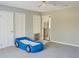Bright bedroom with neutral walls, carpeted floor and a blue car shaped bed at 75 Price Dr, Locust Grove, GA 30248