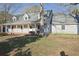 Charming single-story home featuring a covered porch, dormer windows, and a well-maintained front lawn at 75 Price Dr, Locust Grove, GA 30248