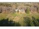 Exterior shot showcasing the single Gathering home and large, open surrounding land at 75 Price Dr, Locust Grove, GA 30248