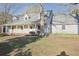 Charming single-story home featuring a covered porch, dormer windows, and a well-maintained front lawn at 75 Price Dr, Locust Grove, GA 30248