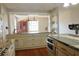 Open eat-in kitchen with stainless appliances, granite countertops, and a passthrough to another room at 75 Price Dr, Locust Grove, GA 30248