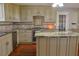 Kitchen features granite countertops, stainless steel appliances, and custom cabinetry at 75 Price Dr, Locust Grove, GA 30248