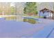 Backyard swimming pool with a gazebo and mature trees at 75 Price Dr, Locust Grove, GA 30248