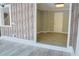 Room with vinyl floors, wood-style paneling, white trim, and neutral paint at 75 Price Dr, Locust Grove, GA 30248