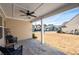 A back porch that has a ceiling fan and cozy seating with a view of the backyard at 146 Point View Dr, Canton, GA 30114