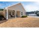A view of the back of the home with a covered porch and a yard with dormant grass at 146 Point View Dr, Canton, GA 30114