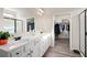 Bathroom featuring double sinks with ample counter space and a view of a walk-in closet at 146 Point View Dr, Canton, GA 30114