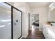 Bright bathroom featuring a glass-enclosed shower, vanity, and view into the bedroom at 146 Point View Dr, Canton, GA 30114