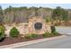 Stone entrance sign for The Villages at River Pointe community with landscaped shrubbery at 146 Point View Dr, Canton, GA 30114