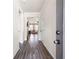 Inviting hallway featuring hardwood floors, neutral walls, and a view into the brightly lit living area at 146 Point View Dr, Canton, GA 30114