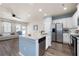 Open-concept kitchen featuring a granite island, stainless steel appliances, and seamless flow to the living area at 146 Point View Dr, Canton, GA 30114