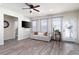 Bright living room with ceiling fan, modern flooring, and an abundance of natural light at 146 Point View Dr, Canton, GA 30114