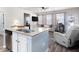 Open-concept living space with granite island, stainless appliances, and view of the adjacent living area at 146 Point View Dr, Canton, GA 30114