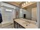 Well-lit bathroom with a large mirror, modern vanity, and a shower-tub combination with a shower curtain at 2030 Habersham Trce, Cumming, GA 30041