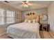Cozy bedroom with a decorative ceiling fan, large bed, and sunny window with bright natural light at 2030 Habersham Trce, Cumming, GA 30041