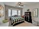 Bright bedroom with a bay window, plaid bedding, and a bookcase creating an inviting ' space at 2030 Habersham Trce, Cumming, GA 30041
