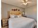 Comfortable bedroom featuring a wood headboard, ceiling fan, and decorative pillows at 2030 Habersham Trce, Cumming, GA 30041