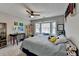 Inviting bedroom featuring a bay window, colorful decor, a ceiling fan, and ample storage shelves at 2030 Habersham Trce, Cumming, GA 30041