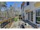 A wooden deck with views of the backyard, seating, table, and string lights, perfect for outdoor enjoyment at 2030 Habersham Trce, Cumming, GA 30041