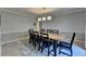 Neutral dining room with a long table, seating for eight, and modern lighting at 2030 Habersham Trce, Cumming, GA 30041