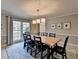 Bright dining room with a large table, modern lighting, and a view of the backyard at 2030 Habersham Trce, Cumming, GA 30041