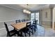Spacious dining room featuring a long wooden table, seating, and elegant overhead lighting at 2030 Habersham Trce, Cumming, GA 30041