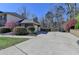 Long driveway leading to a spacious two-car garage with lush landscaping and surrounding trees at 2030 Habersham Trce, Cumming, GA 30041