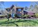 Attractive brick home showcasing a bright blue front door and beautiful, mature landscaping at 2030 Habersham Trce, Cumming, GA 30041