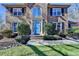 Close-up of a stylish brick house with an inviting blue door and manicured shrubs at 2030 Habersham Trce, Cumming, GA 30041