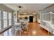 Eat-in kitchen with white cabinets, stainless steel appliances, hardwood floors and access to the staircase at 2030 Habersham Trce, Cumming, GA 30041