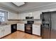 This kitchen offers updated appliances, white cabinets, and a window above the sink at 2030 Habersham Trce, Cumming, GA 30041
