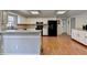 Spacious Kitchen with white cabinets and stainless steel appliances and hardwood floors at 2030 Habersham Trce, Cumming, GA 30041