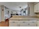 Open-concept kitchen flows into the living area; it is equipped with bar seating and generous counter space at 2030 Habersham Trce, Cumming, GA 30041