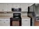 This kitchen features a microwave over the stove and a stainless steel refrigerator at 2030 Habersham Trce, Cumming, GA 30041