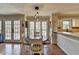 Charming eat-in kitchen with hardwood floors, black appliances, and a breakfast nook at 2030 Habersham Trce, Cumming, GA 30041
