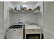 Convenient laundry room with Maytag washer and dryer and built-in shelving for organization at 2030 Habersham Trce, Cumming, GA 30041
