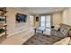 Comfortable living room featuring a large sectional sofa, TV, and shelf at 2030 Habersham Trce, Cumming, GA 30041