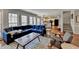 Bright living room features a comfortable blue sofa, area rug, and hardwood floors with an open view to the kitchen at 2030 Habersham Trce, Cumming, GA 30041