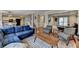 Spacious living room with a blue couch and stylish herringbone wood coffee table at 2030 Habersham Trce, Cumming, GA 30041