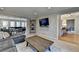 Bright living room showcasing a sectional sofa and easy access to other rooms at 2030 Habersham Trce, Cumming, GA 30041