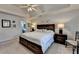 Bright main bedroom with a tray ceiling, ceiling fan, and ensuite bathroom access at 2030 Habersham Trce, Cumming, GA 30041