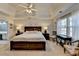 Main bedroom features a tray ceiling, two bedside tables, two occasional chairs, and large windows at 2030 Habersham Trce, Cumming, GA 30041