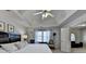 Well-lit main bedroom boasts a tray ceiling and backyard view at 2030 Habersham Trce, Cumming, GA 30041