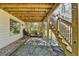 The covered patio includes stone pavers, stairs to an upper deck, and plenty of natural light, enhancing outdoor living at 2030 Habersham Trce, Cumming, GA 30041