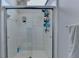 Modern tiled shower stall featuring glass doors and updated fixtures in a bright, clean bathroom at 2030 Habersham Trce, Cumming, GA 30041