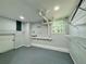 Functional laundry room with storage shelves, utility sink, window, and washer/dryer hookups at 3210 Ebenezer Rd, Marietta, GA 30066