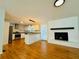 Open concept living room and kitchen featuring a fireplace and hardwood floors at 3210 Ebenezer Rd, Marietta, GA 30066