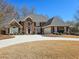 Beautiful two-story brick home with a well-manicured front yard and curved driveway at 5189 Brooke Farm Dr, Atlanta, GA 30338